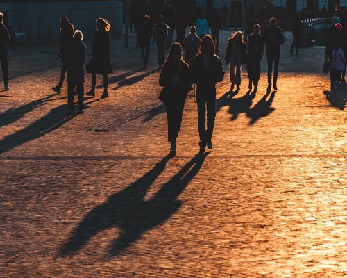 Walking calmly in an Italian city park at sunset